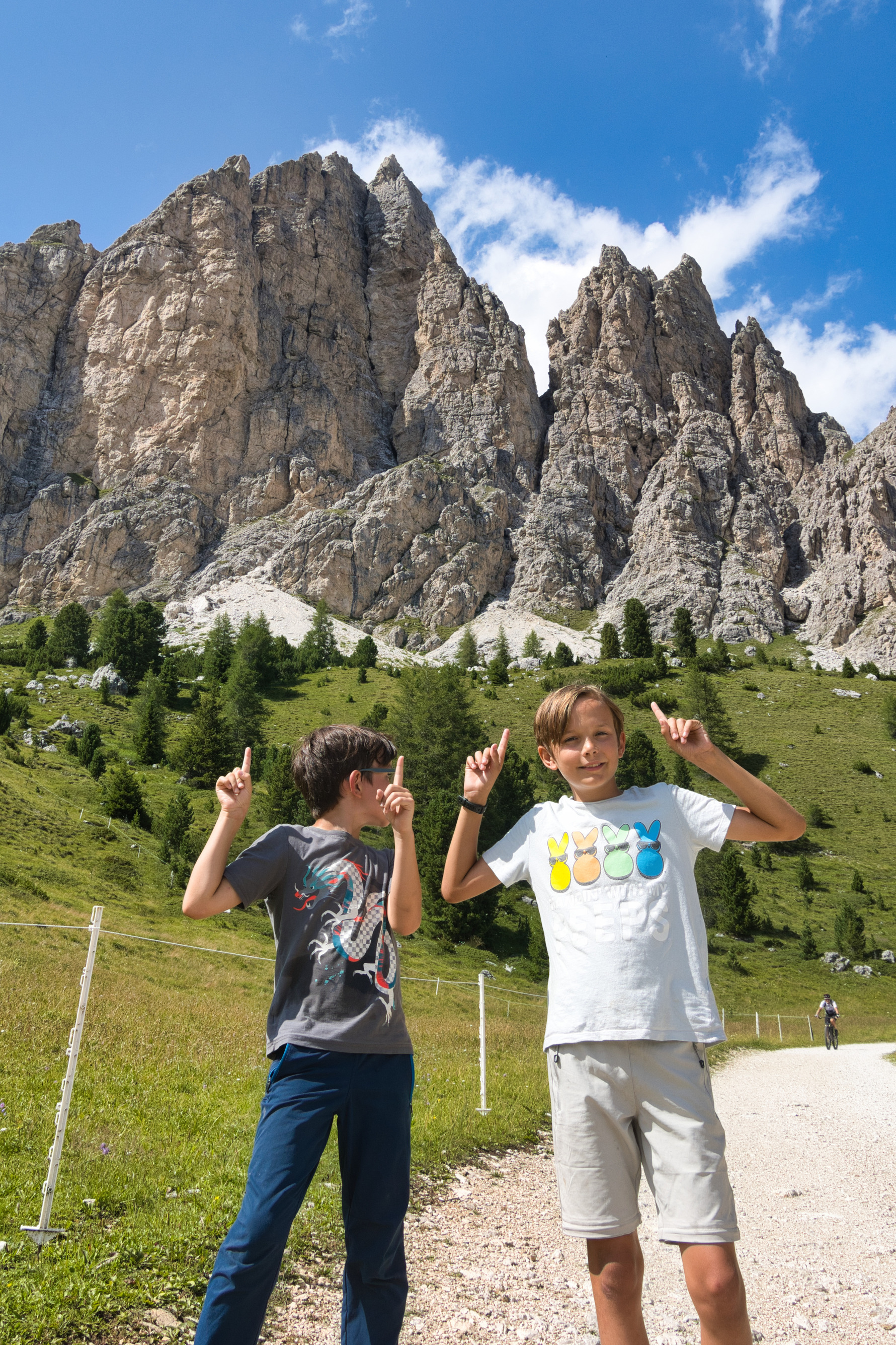 The older boys pointing out the mountain they just climbed (the highest point in the background)