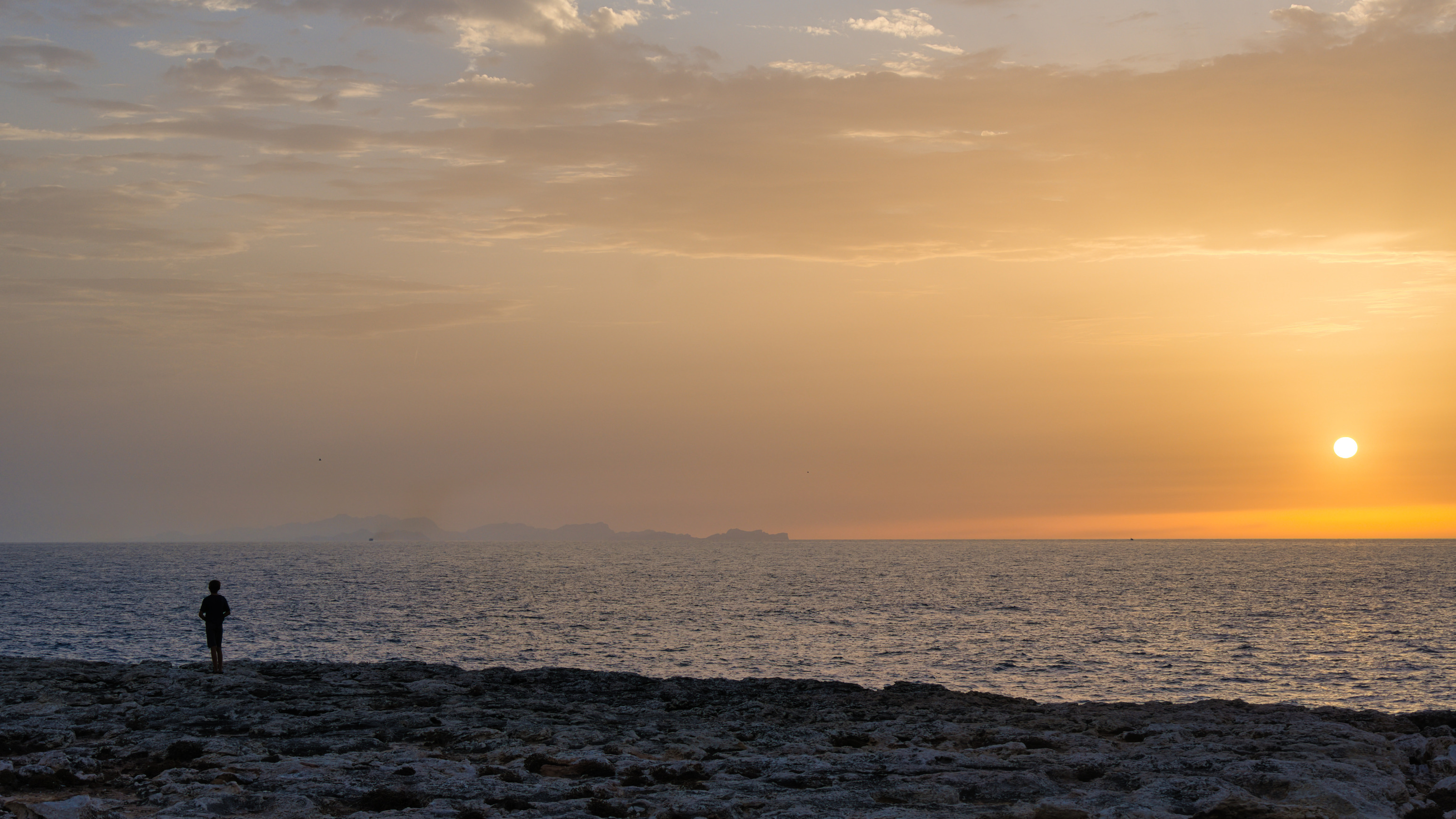 Luke looking out at the sunset and Mallorca